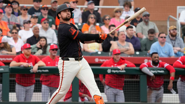 Feb 26, 2024; Scottsdale, Arizona, USA; San Francisco Giants third baseman JD Davis (7) hits against the Los Angeles Angels in the first inning at Scottsdale Stadium.